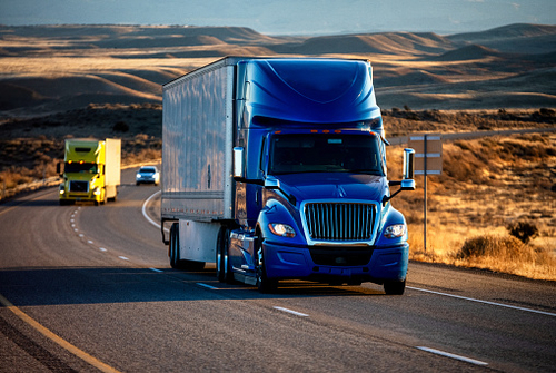 Freight trucks traveling along a highway