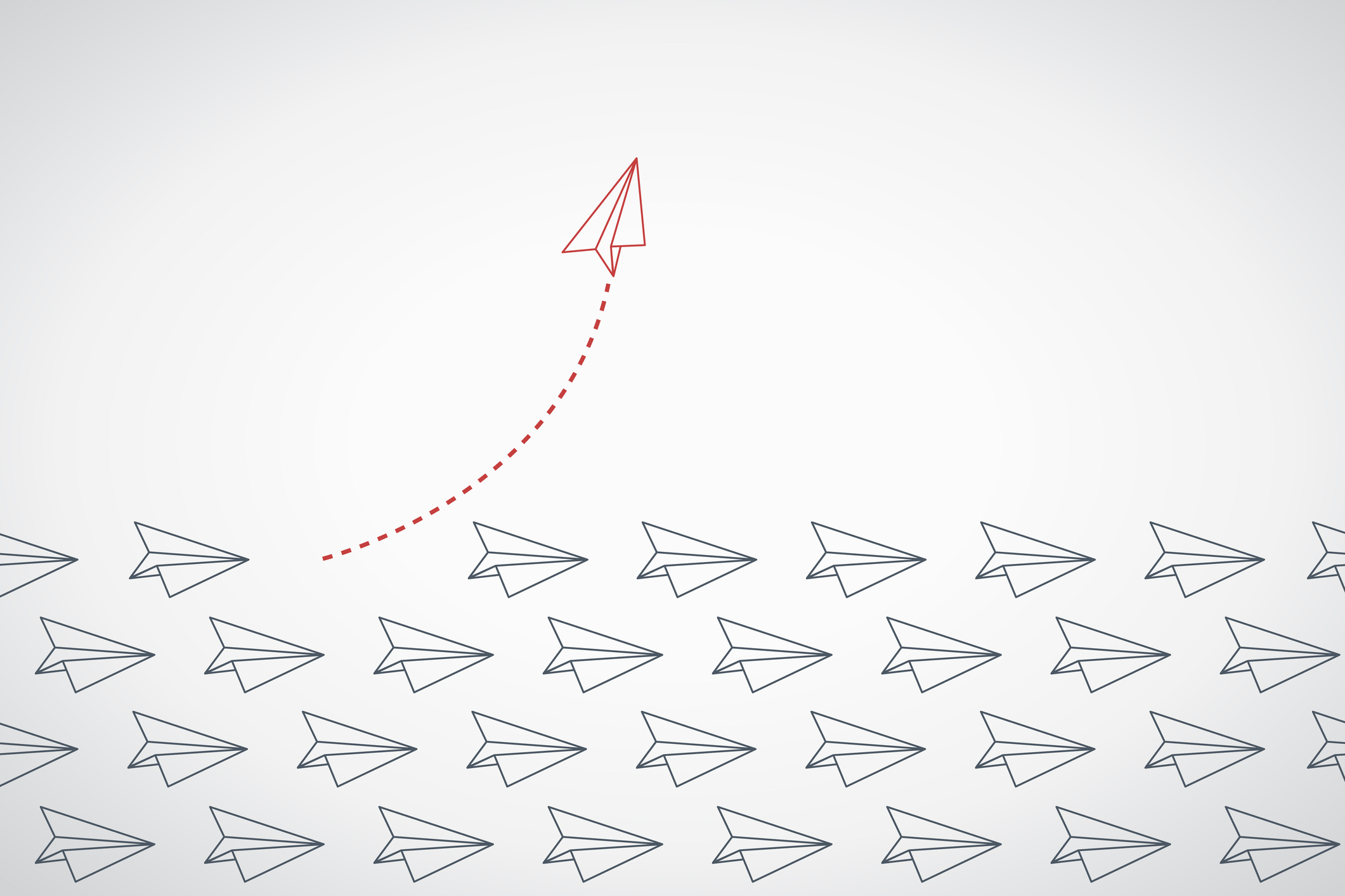 A single paper airplane soars above the rest, forging a new path